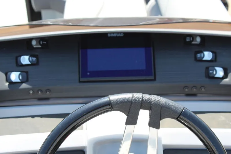 Slide: The Image of Steering wheel and dashboard of 2023 Bennington 23 LSR boat with control panel. - 21