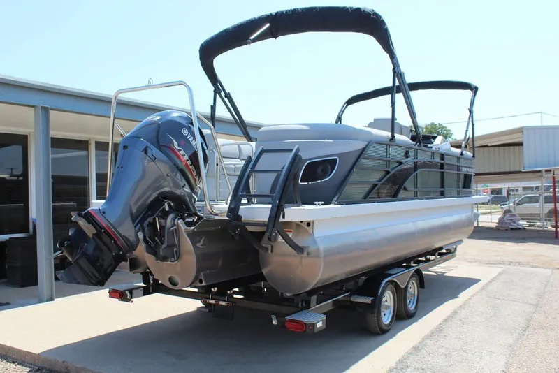 Slide: The Image of 2023 Bennington 23 LSR pontoon boat with Yamaha outboard motor on trailer. - 6