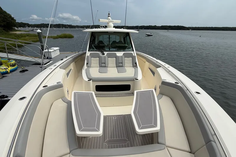 Slide: The Image of 2021 Scout 530 LXF luxury boat with spacious seating on calm waters. - 45