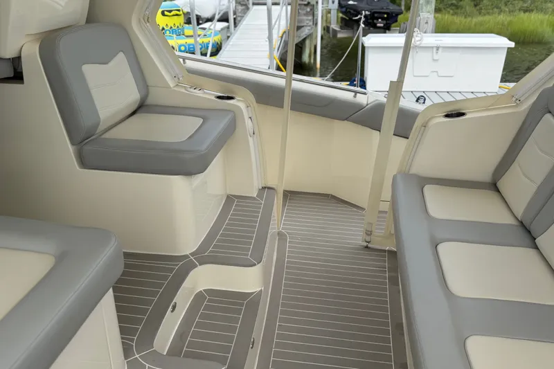 Slide: The Image of Interior of 2021 Scout 530 LXF boat with gray and white seating. - 16