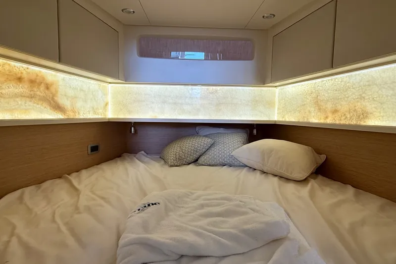 Slide: The Image of Luxurious cabin interior of 2021 Scout 530 LXF yacht with cozy bedding and ambient lighting. - 36