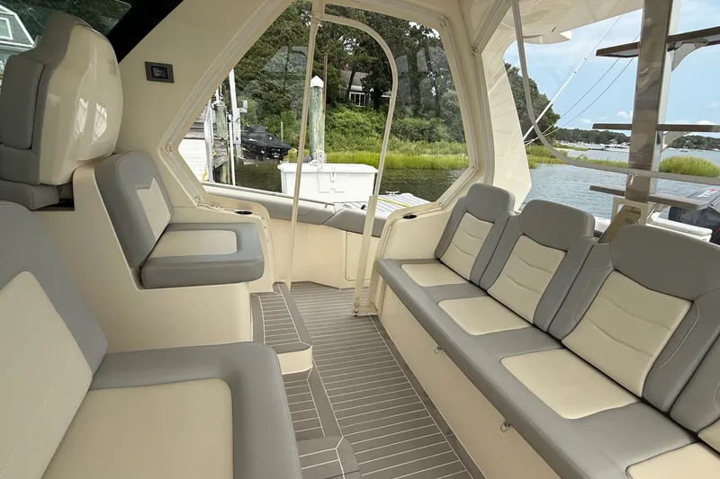Slide: The Image of Interior of 2021 Scout 530 LXF boat with luxurious seating and scenic water view. - 18