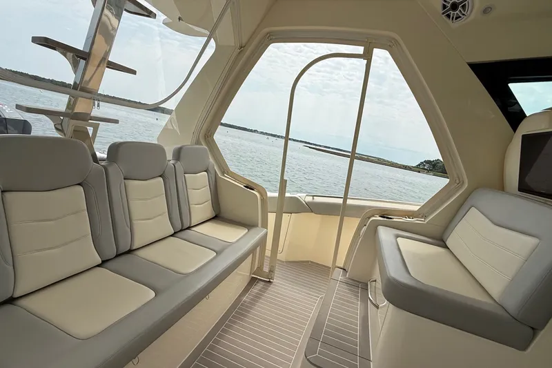 Slide: The Image of Interior view of 2021 Scout 530 LXF yacht with luxurious seating and ocean backdrop. - 15