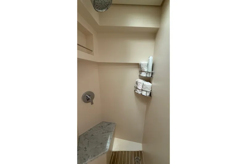Slide: The Image of Shower area in 2021 Scout 530 LXF boat, featuring modern fixtures and storage shelves. - 38