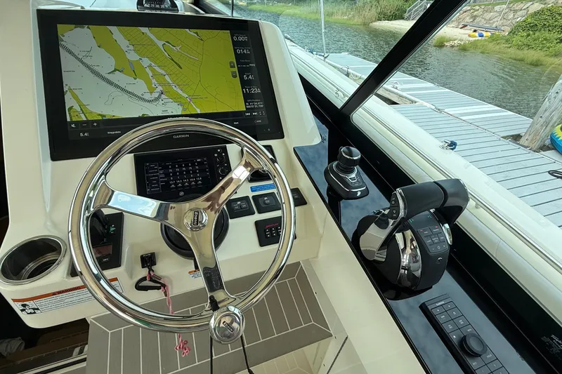 Slide: The Image of 2021 Scout 530 LXF boat helm with Garmin navigation display and controls. - 23