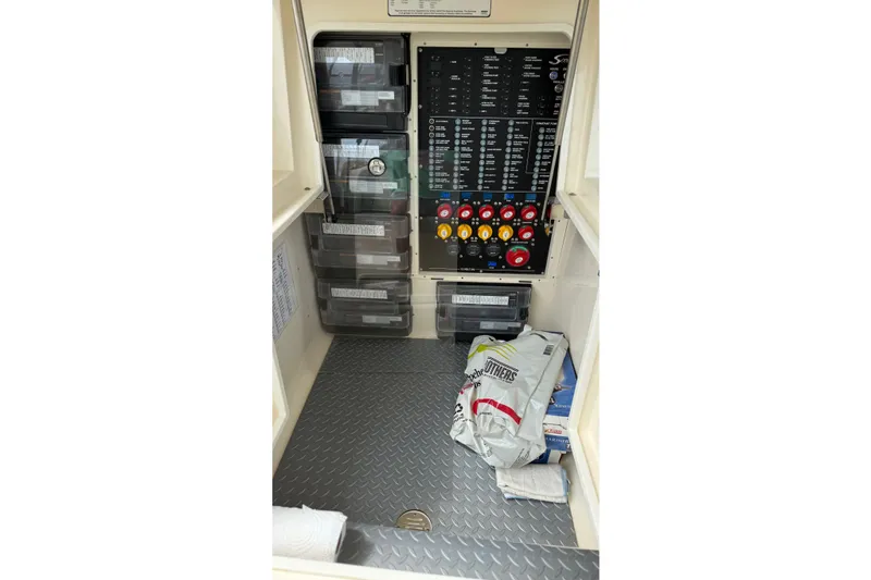 Slide: The Image of Electrical panel and storage area inside 2021 Scout 530 LXF boat. - 13