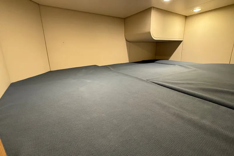 Slide: The Image of 2021 Scout 530 LXF cabin interior with comfortable bedding and modern lighting. - 42