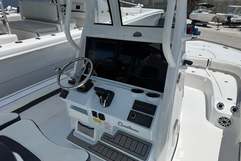 Slide: The Image of 2027 Tidewater 2500 Carolina Bay boat console with steering wheel and controls. - 5