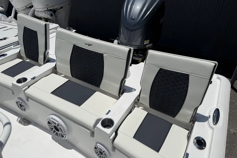 Slide: The Image of 2027 Tidewater 2500 Carolina Bay boat seats with cup holders and speakers. - 10