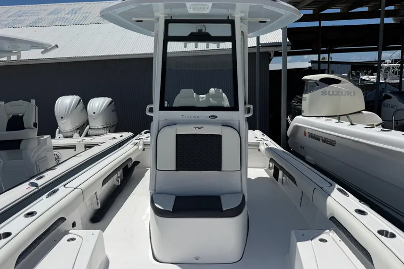 Slide: The Image of 2027 Tidewater 2500 Carolina Bay boat with center console and Suzuki engines in marina. - 7