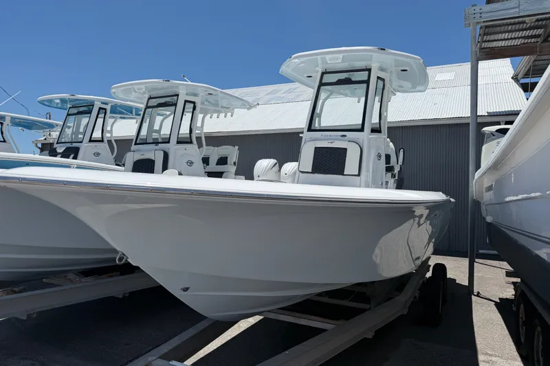 The Image of 2027 Tidewater 2500 Carolina Bay boat displayed in a marina under clear blue skies. - 0