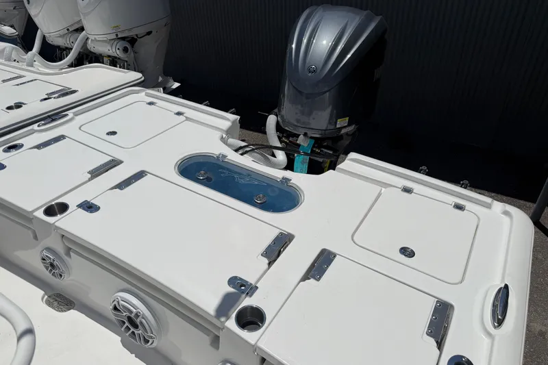Slide: The Image of 2027 Tidewater 2500 Carolina Bay boat deck with outboard motor and storage compartments. - 9