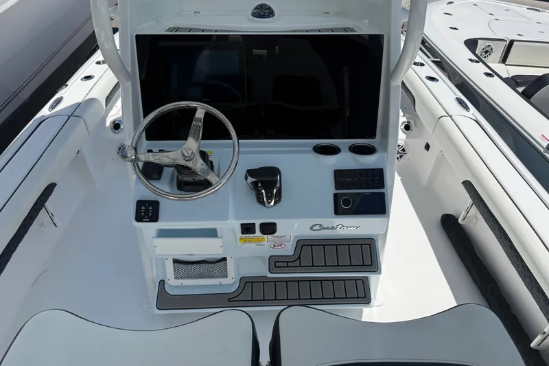 Slide: The Image of 2027 Tidewater 2500 Carolina Bay boat console with steering wheel and controls. - 4