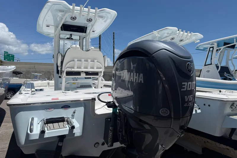 Slide: The Image of 2027 Tidewater 2500 Carolina Bay boat with Yamaha 300 V6 engine, docked under clear skies. - 2