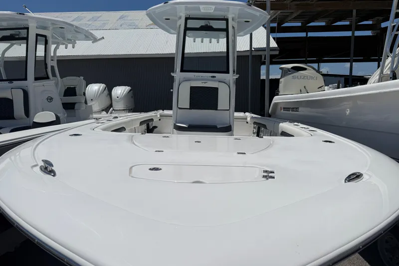 Slide: The Image of 2027 Tidewater 2500 Carolina Bay boat with sleek white deck and modern design. - 1