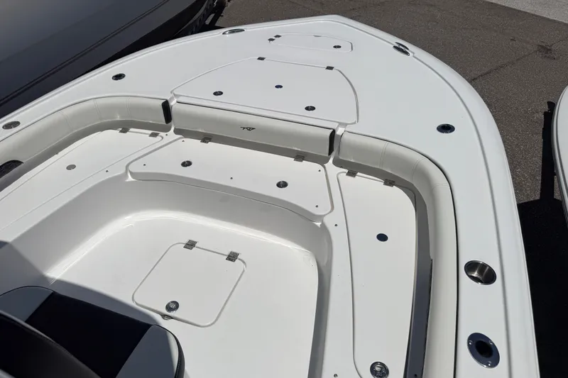 Slide: The Image of 2027 Tidewater 2500 Carolina Bay boat deck with seating and storage compartments. - 6