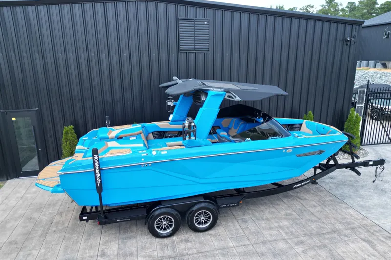 Slide: The Image of 2024 Nautique Super Air Nautique G23 boat in vibrant blue on trailer. - 19