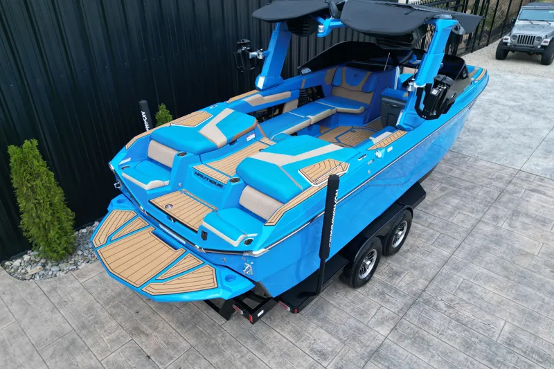 Slide: The Image of 2024 Nautique Super Air Nautique G23 boat in vibrant blue on a trailer. - 15