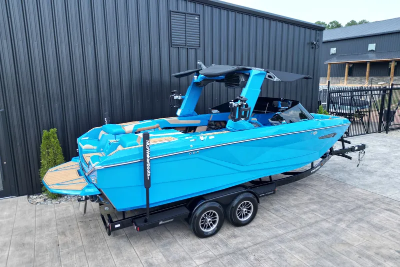 Slide: The Image of 2024 Nautique Super Air Nautique G23 boat in vibrant blue on trailer. - 17