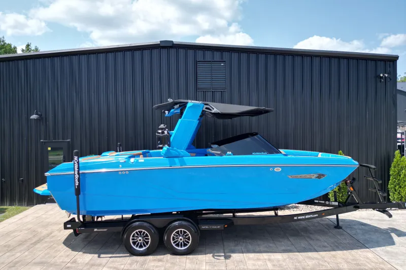 Slide: The Image of 2024 Nautique Super Air Nautique G23 boat in vibrant blue on trailer. - 22