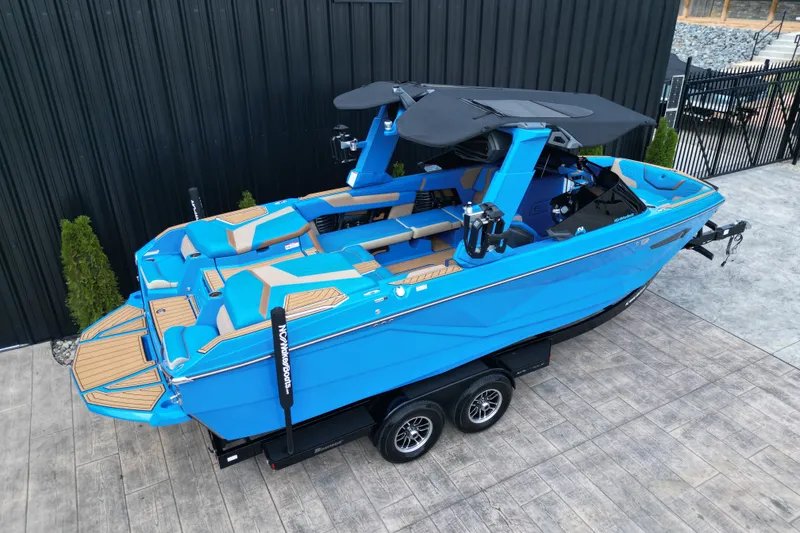 Slide: The Image of 2024 Nautique Super Air Nautique G23 boat in vibrant blue on a trailer. - 16