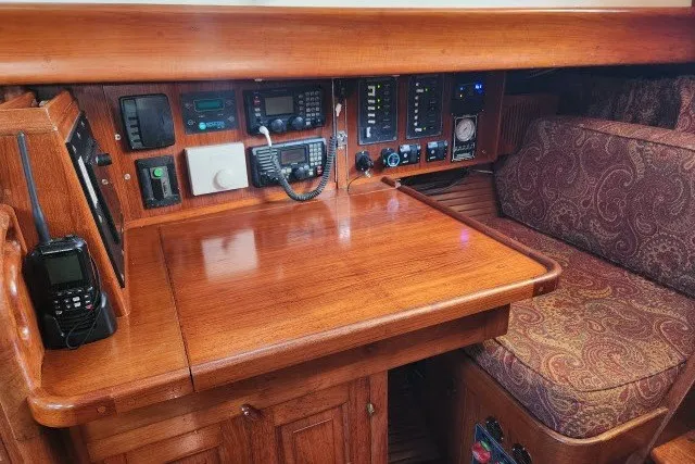 Slide: The Image of Navigation station of a 1979 Hans Christian 38 Traditional sailboat with wooden finish and equipment. - 11