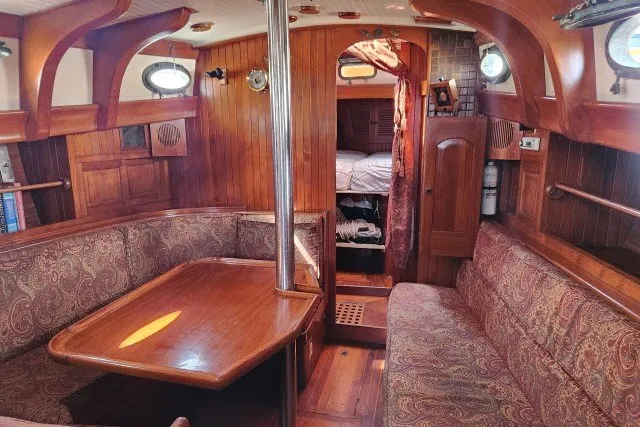 Slide: The Image of 1979 Hans Christian 38 Traditional yacht interior with wooden furnishings and cozy seating area. - 24
