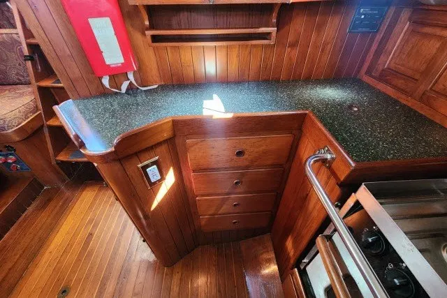 Slide: The Image of 1979 Hans Christian 38 Traditional yacht interior with wooden cabinetry and countertop. - 14