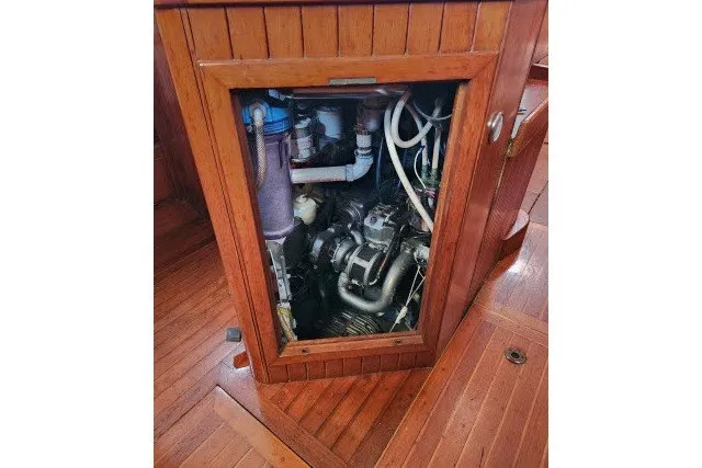 Slide: The Image of Engine compartment of a 1979 Hans Christian 38 Traditional sailboat with wooden paneling. - 41