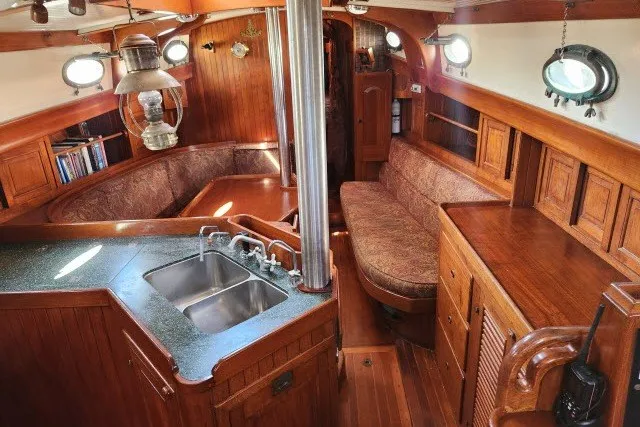 Slide: The Image of Interior of 1979 Hans Christian 38 Traditional sailboat with wood finish and cozy seating area. - 17