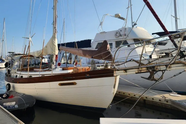 Slide: The Image of 1979 Hans Christian 38 Traditional sailboat docked at a marina, showcasing classic design. - 42
