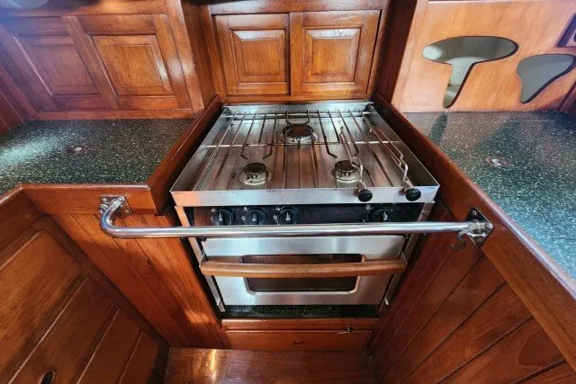 Slide: The Image of Wood-paneled kitchen with stainless steel stove in 1979 Hans Christian 38 Traditional yacht. - 15