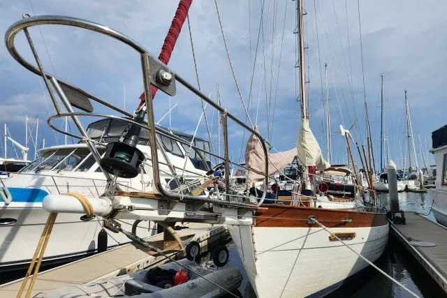 Slide: The Image of 1979 Hans Christian 38 Traditional sailboat docked at a marina, showcasing classic design. - 43