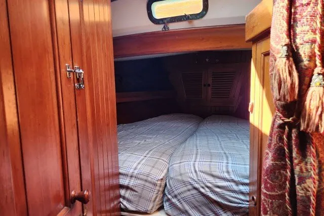 Slide: The Image of Cozy cabin interior of 1979 Hans Christian 38 Traditional sailboat with wooden furnishings. - 26