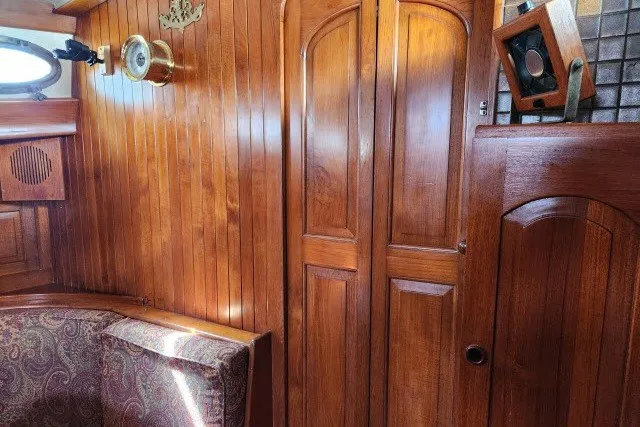 Slide: The Image of Interior of 1979 Hans Christian 38 Traditional sailboat with wooden paneling and seating. - 25