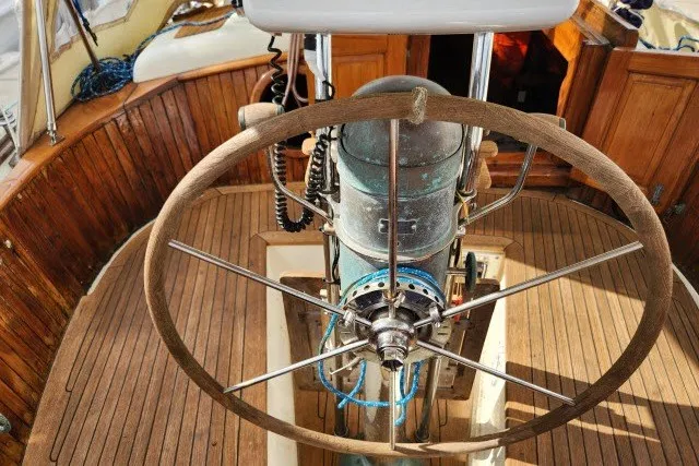 Slide: The Image of Wooden helm of 1979 Hans Christian 38 Traditional sailboat, showcasing classic nautical design. - 48