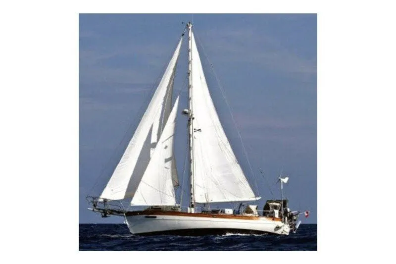 Slide: The Image of 1979 Hans Christian 38 Traditional sailboat navigating open waters under full sail. - 2