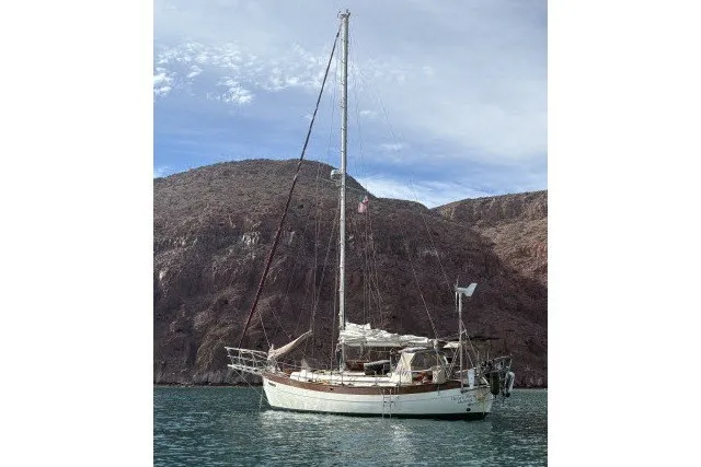 Slide: The Image of Sailboat anchored in scenic bay, 1979 Hans Christian 38 Traditional model. - 58