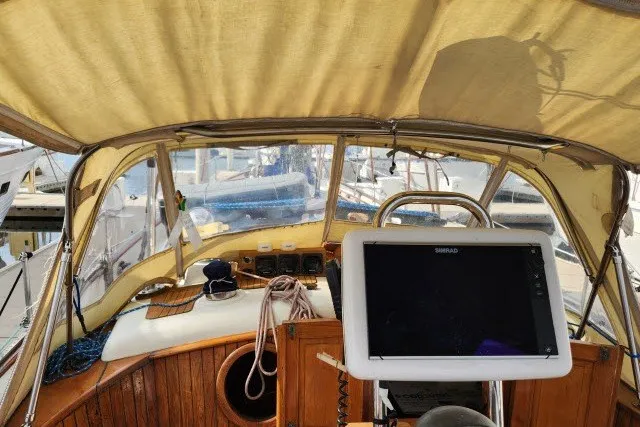 Slide: The Image of 1979 Hans Christian 38 Traditional sailboat cockpit with navigation equipment and canopy. - 49