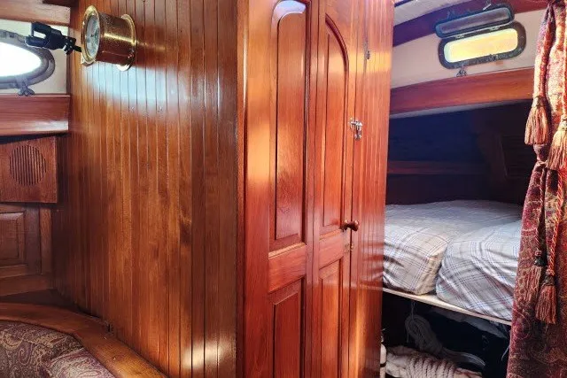 Slide: The Image of Interior of 1979 Hans Christian 38 Traditional sailboat with wooden paneling and cozy cabin. - 29