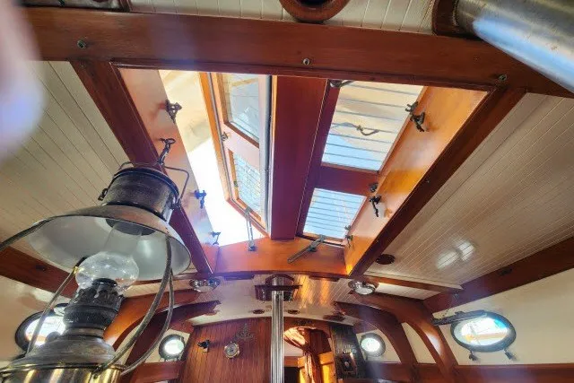 Slide: The Image of Interior view of 1979 Hans Christian 38 Traditional sailboat with wooden finishes and skylight. - 33