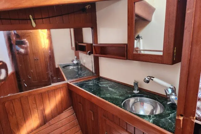 Slide: The Image of Interior of 1979 Hans Christian 38 Traditional yacht with wooden cabinetry and marble countertop. - 30