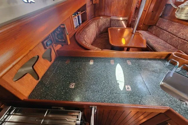 Slide: The Image of 1979 Hans Christian 38 Traditional yacht interior with wood finish and cozy seating area. - 16