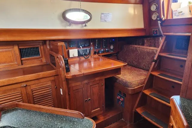 Slide: The Image of Interior of 1979 Hans Christian 38 Traditional sailboat with wooden cabinetry and navigation station. - 10