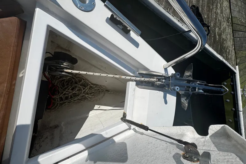 Slide: The Image of Anchor compartment of a 2016 Axopar 28 Cabin boat with rope and anchor. - 12