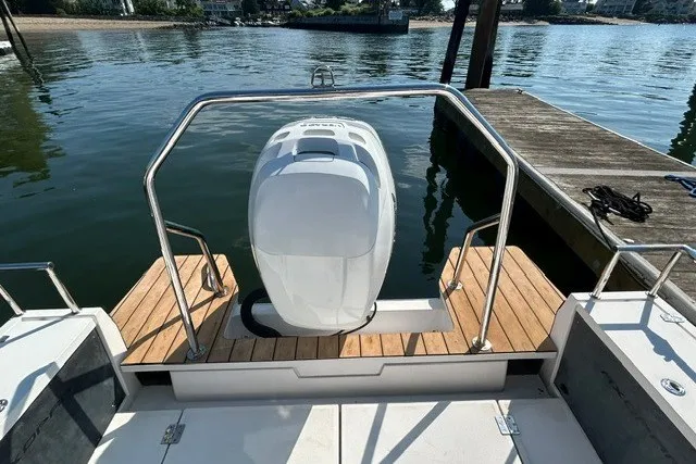 Slide: The Image of Axopar 28 Cabin 2016 boat with outboard motor, docked on calm water. - 6