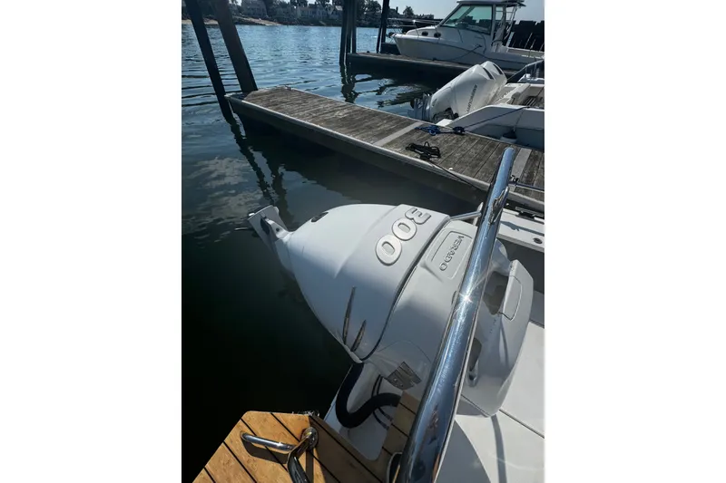 Slide: The Image of 2016 Axopar 28 Cabin boat docked with a 300 horsepower outboard engine. - 7