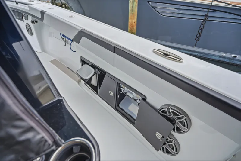 Slide: The Image of 2025 Yellowfin 42 Offshore boat interior with storage compartments and speakers. - 26
