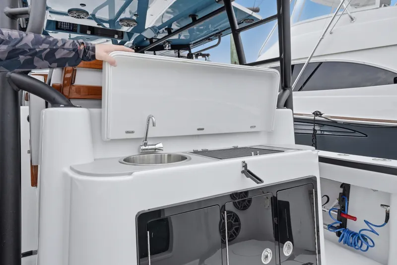 Slide: The Image of 2025 Yellowfin 42 Offshore boat with onboard sink and storage area. - 58