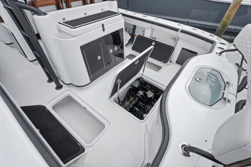Slide: The Image of 2025 Yellowfin 42 Offshore boat interior with open storage compartments and engine access. - 36